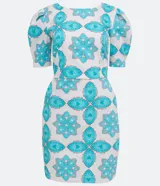 Vestido corto blanco con estampado de flores y corazones en color celeste, de corte recto, con mangas abullonadas y lazo en la espalda.