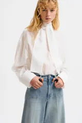 Pantalón jean de denim de algodón con leve stretch, tiro alto y pierna ancha. Cuenta con bolsillos tipo parche en el frente y raya marcada en ambas piernas.