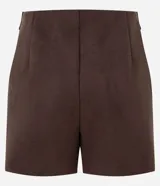 Short pollera marrón de gamuza sintética con diseño cruzado en el frente, corte recto y cierre lateral con botón.