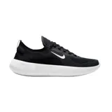 Championes Nike Free de running, color negro con suela blanca y logo de la marca en el lateral. Diseño de tejido transpirable y suela flexible.