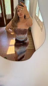 Conjunto de dos piezas compuesto por un top strapless y una falda midi con tajo lateral. Presenta un estampado tipo tie-dye en tonos marrones y celestes. Confeccionado en tejido elástico.