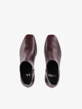 Botas de caña media en cuero negro, con punta semi redondeada y taco cuadrado forrado a tono. Poseen cierre lateral interno.