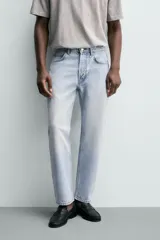 Jeans regular fit de denim de algodón en color gris con efecto lavado, tiro medio, diseño de cinco bolsillos y cierre frontal con botones.