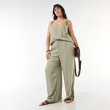Pantalón ancho de lino mezclado color verde claro, de corte holgado y tiro con elástico.