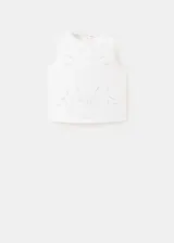 Top blanco sin mangas de algodón, con cuello redondo y detalles bordados.