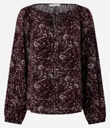 Blusa de viscosa con estampado de follaje, escote canoa con lazo delantero y mangas largas abullonadas.