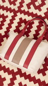 Bolso tipo tote bag de símil cuero con diseño de bloques de color verticales: verde oliva, negro y beige. Posee dos asas de mano negras y una correa ajustable desmontable del mismo color verde oliva del cuerpo principal.