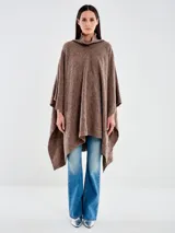 Poncho de lana color marrón con cuello alto acanalado y silueta amplia. Presenta un tejido de punto con diseño texturizado de rombos y caída relajada.