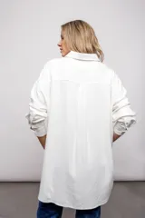 Camisa blanca de manga larga, con botones y cuello.