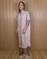 Túnica midi camisera de rayas verticales en tonos rosado y blanco, con cuello camisero, manga corta y cierre frontal con botones.
