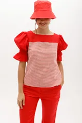 Blusa de mangas cortas abullonadas color verde claro, con escote cuadrado y cuerpo a rayas horizontales grises y blancas.