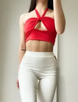 Top corto rojo con escote halter y abertura en el centro del pecho.