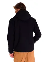Chaqueta negra con cierre frontal, capucha forrada en sherpa gris y diseño de corte recto. Cuenta con bolsillos laterales y un bolsillo vertical en el pecho.