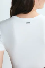 Remera de cuello redondo y manga corta, confeccionada en tejido de punto acanalado, con un ajuste al cuerpo.