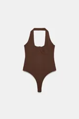 Body color marrón de cuello halter y escote corazón con aros metálicos ocultos. Presenta un diseño estilo corsé y cierre en el bajo con botones a presión.