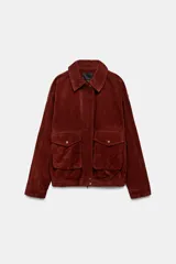 Cazadora de piel color bordó con cuello solapa, manga larga y dos bolsillos de plastrón con solapa en el delantero. Cierre frontal con cremallera oculta por solapa.