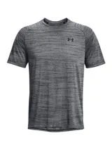 Remera deportiva Under Armour de manga corta, confeccionada en tejido técnico ultrasuave de secado rápido con textura jaspeada. Presenta cuello redondo y logo de la marca estampado en el pecho.