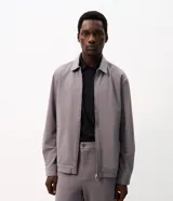Campera Marfinno para hombre, de sarga texturizada color gris, corte regular, cuello camisero, cierre frontal con cremallera y bolsillos laterales embutidos.