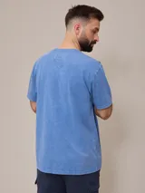 Remera básica de cuello redondo con bolsillo frontal, confeccionada en algodón con efecto de lavado gastado.