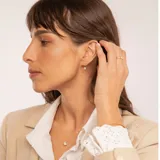 Conjunto de gargantilla y aros en oro 18k, con dijes circulares que presentan una circonia central engastada.