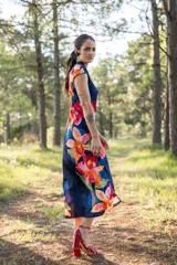 Vestido midi de corte recto y estilo japonés, color azul marino con gran estampado floral multicolor, cuello elevado con drapeado y mangas cortas integradas.