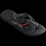 Sandalias tipo ojota Havaianas modelo Power 2.0, color negro con detalles en azul oscuro en las tiras. Presentan un diseño ergonómico con textura antideslizante en la base y tiras con relieve decorativo.