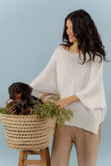 Buzo de hilo con tejido de punto fino, de corte holgado y mangas tres cuartos. Presenta un diseño versátil con cuello redondo amplio y acabado ligeramente brillante.