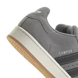 Championes urbanos Adidas modelo Campus 00s, color gris con las icónicas tres tiras laterales en negro. Confeccionados en gamuza, cuentan con suela de goma color crema y diseño de inspiración retro.
