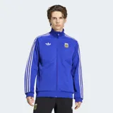 Campera deportiva Adidas de la Selección Argentina, color azul con las icónicas tres tiras blancas en las mangas. Presenta cuello alto, cierre frontal, logo del Trifolio bordado en el pecho y escudo de la AFA.