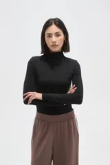 Polera de poliamida ajustada al cuerpo, con cuello alto y mangas largas.