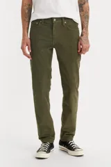 Pantalón de pana verde oliva, corte slim fit, tiro medio y cinco bolsillos.
