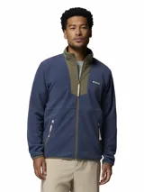 Campera de polar para hombre con cierre frontal completo. Presenta un diseño de bloques de color con cuerpo en azul y detalles en verde oliva en el cuello y la solapa central. Incluye bolsillos laterales con cierre y logo de la marca bordado en el pecho.