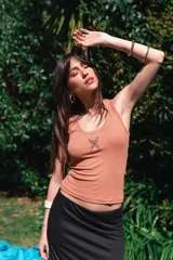 Musculosa de viscosa color blanco, de corte ajustado y diseño acanalado, con un pequeño estampado negro en el centro del pecho.