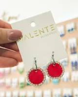 Aros colgantes con aro de acero plateado y dije circular rojo con borde de strass.