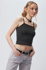 Top ajustado al cuerpo con estampado a cuadros blancos y negros, breteles finos y ribete negro en escote y sisas.