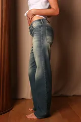 Pantalón de jean azul con efecto lavado, corte recto y tiro medio.