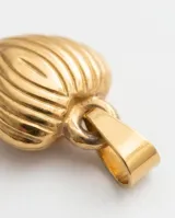 Dije en forma de corazón con diseño estriado vertical, acabado en tono dorado.