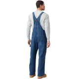 Overol de jean clásico con diseño funcional, confeccionado en denim resistente con acabado stonewashed. Cuenta con tirantes ajustables, múltiples bolsillos frontales, lazo para martillo en la pierna izquierda y bolsillo doble para herramientas en la derecha.
