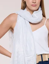 Pashmina rectangular de caída fluida, color blanco con efecto brillante y patrón geométrico jacquard en tono sobre tono. Presenta terminación de flecos finos en los extremos.