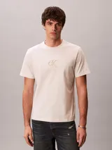 Remera de manga corta Calvin Klein color beige, de corte regular y cuello redondo, con el monograma de la marca estampado en el pecho.