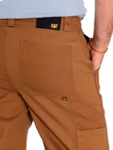 Pantalon tipo carpenter de corte recto, color bronce, confeccionado en tela twill resistente. Cuenta con cierre de cremallera, ajuste de botón, bolsillos laterales, bolsillos traseros tipo parche, trabilla para martillo y bolsillo utilitario en el muslo.