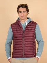 Chaleco acolchado de hombre color bordó, confeccionado en nylon reciclado con diseño matelasse horizontal y calce slim fit. Cuenta con cierre frontal y cuello alto.
