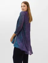 Conjunto de tres piezas compuesto por una musculosa recta, un cardigan liviano de frente abierto con mangas 3/4 y un pantalón de seda fría. La musculosa y el cardigan están confeccionados en tejido plisado con hilos metalizados tornasolados. Incluye collar removible y forro interno a tono.