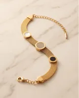 Pulsera rígida de acero con baño dorado, de diseño mallado, con tres dijes circulares incrustados con detalles en ónix, nácar y circonias.