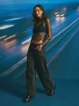 Jean de corte wide leg en color celeste claro con lavado desgastado. Presenta un diseño de cinco bolsillos, incluyendo bolsillos laterales tipo cargo, cierre frontal con botón y bragueta, y costuras reforzadas en las piernas.