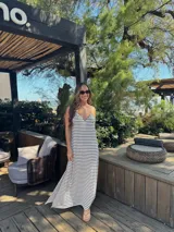 Vestido largo de jersey, color negro con rayas horizontales blancas, corte recto y tirantes finos.