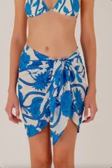 Pareo corto de playa con estampado floral en tonos azules y blancos.