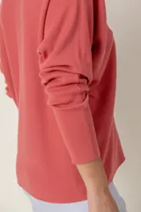 Cárdigan negro de punto con escote en V y cierre frontal con botones marrones.