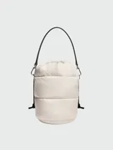 Bolso tipo saco (bucket bag) acolchado color crema, con cordón ajustable en la parte superior y asas cortas negras.