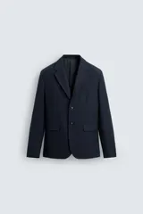 Blazer regular fit color azul marino, con cuello con solapas de muesca, manga larga con puño abotonado y bolsillos de solapa en la cadera. Incluye bolsillo interior y abertura en el centro de la espalda. Cierre frontal de botonadura simple.